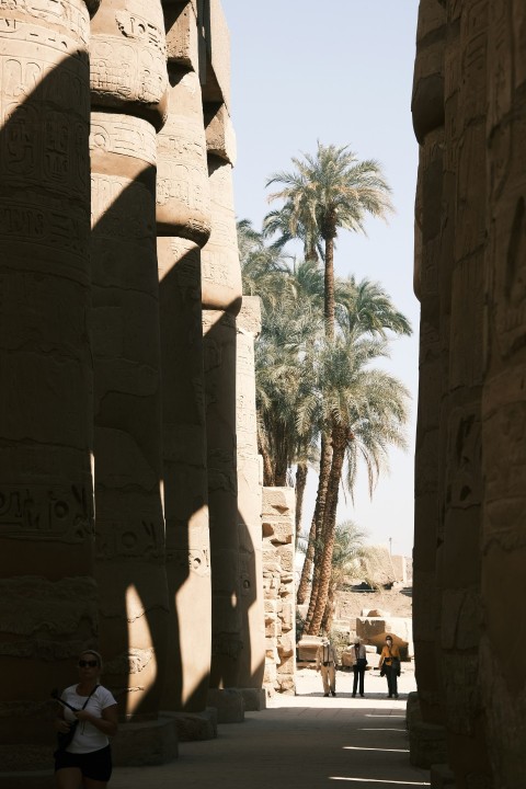 a person standing between stone pillars d2u