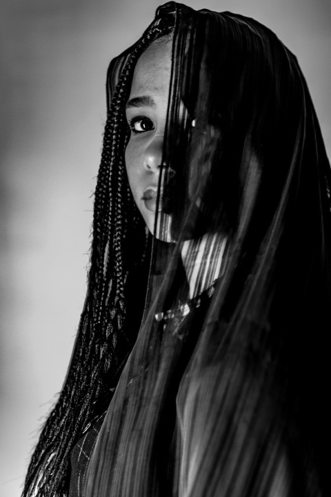 a black and white photo of a woman with long hair