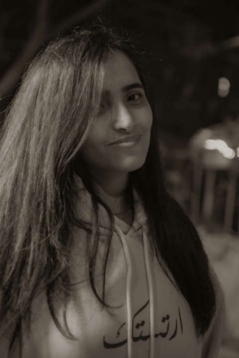 a woman with long hair is posing for a picture