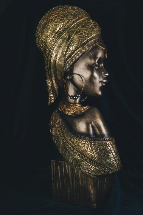 a statue of a woman wearing a gold headdress