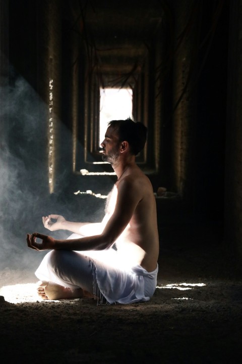 man meditating inside building H47uK4Q98