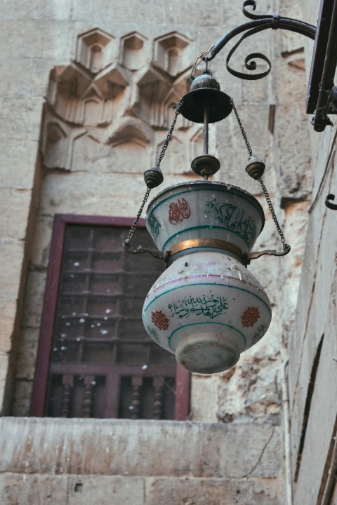 a lamp hanging from the side of a building