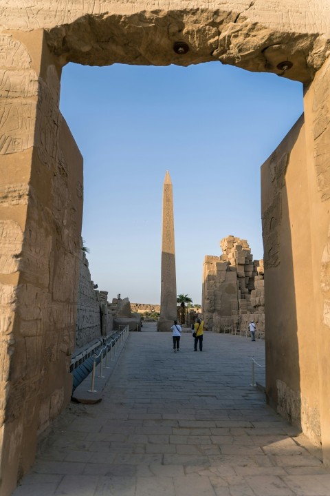 a tall obelisk towering over a city street lM