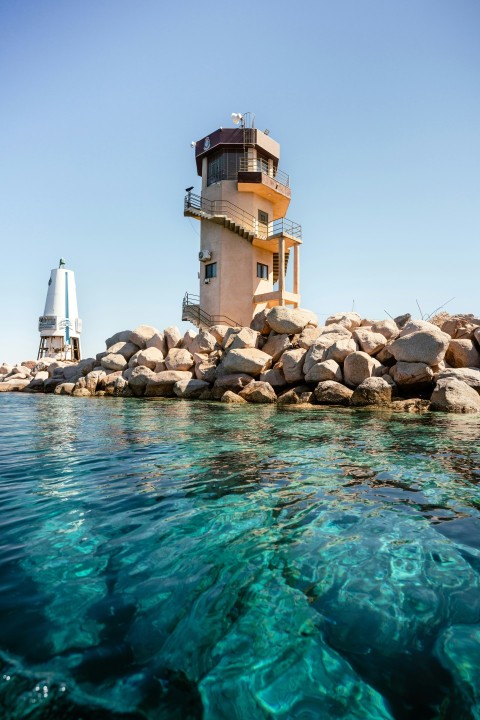 a light house sitting on top of a rocky shore