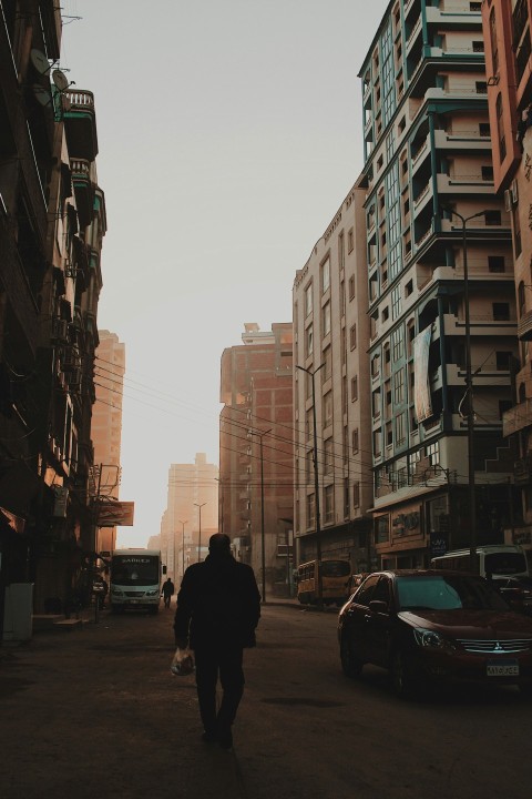 man walking beside car