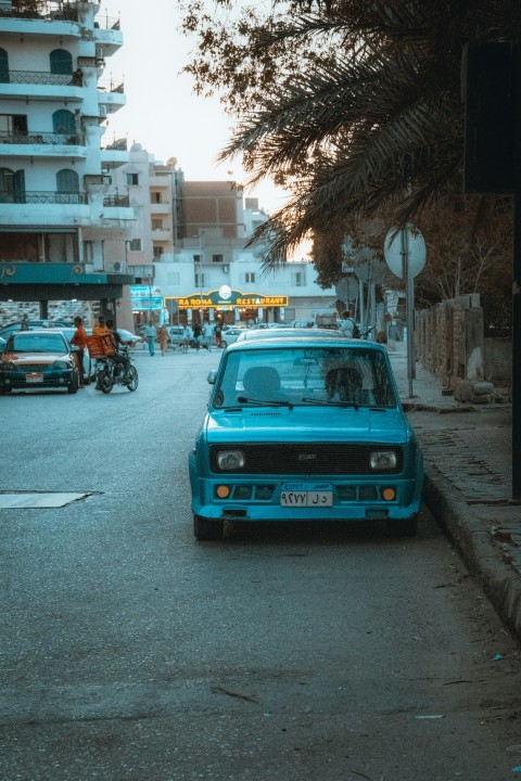 a blue car parked on the side of the road ZVnTg