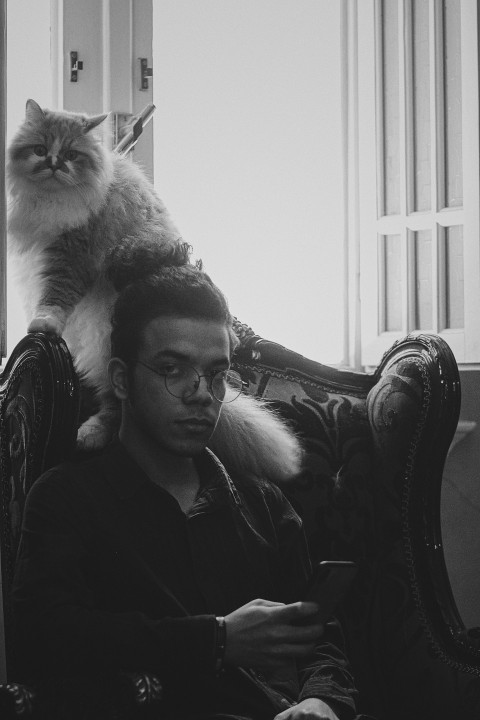 man in black long sleeve shirt sitting on chair