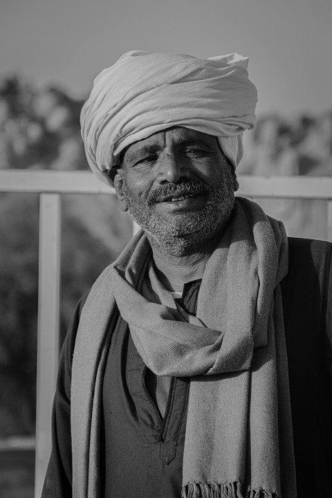 a black and white photo of a man wearing a turban