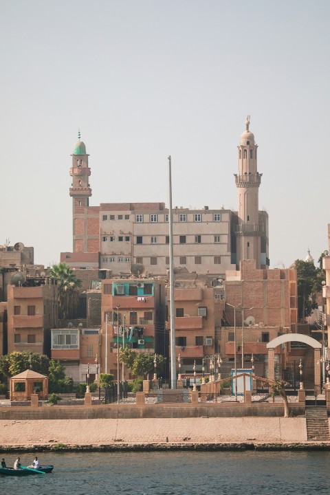 a boat in a body of water near a city juKKAv2