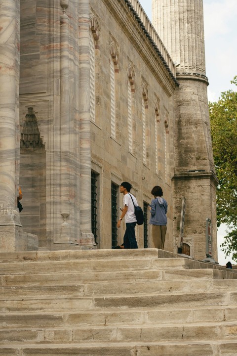 a couple of people that are standing on some steps