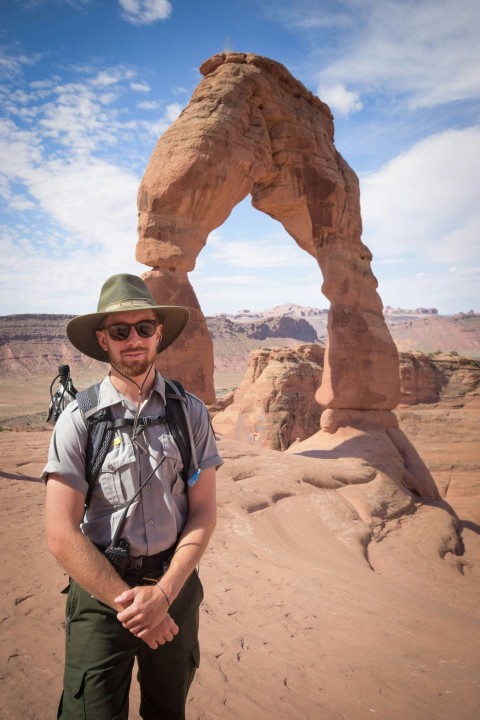 man standing near delicate arch