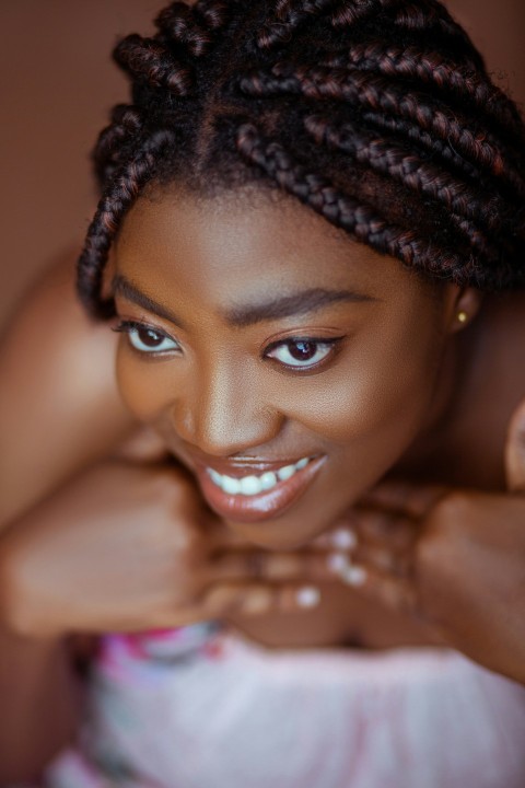 a woman with braids posing for a picture