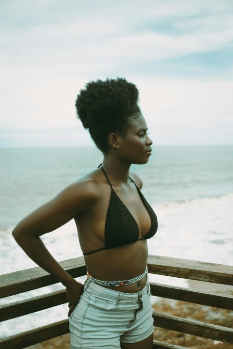 a woman in a bikini standing on a deck