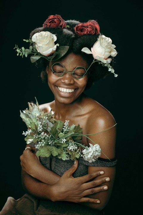 a woman with glasses and flowers on her head