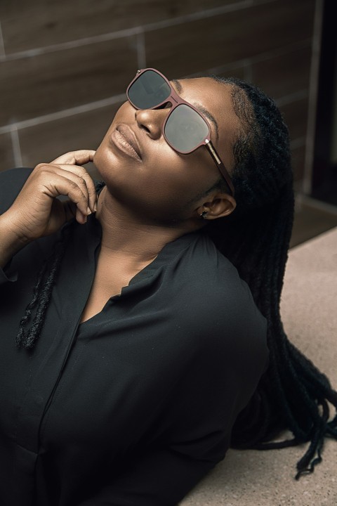 a woman wearing sunglasses and a black shirt