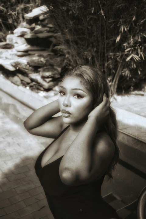 a woman in a bathing suit leaning on a bench