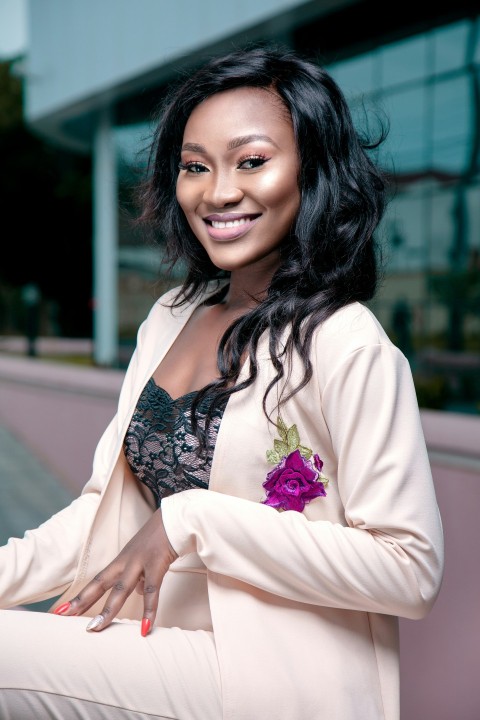 woman in white cardigan smiling