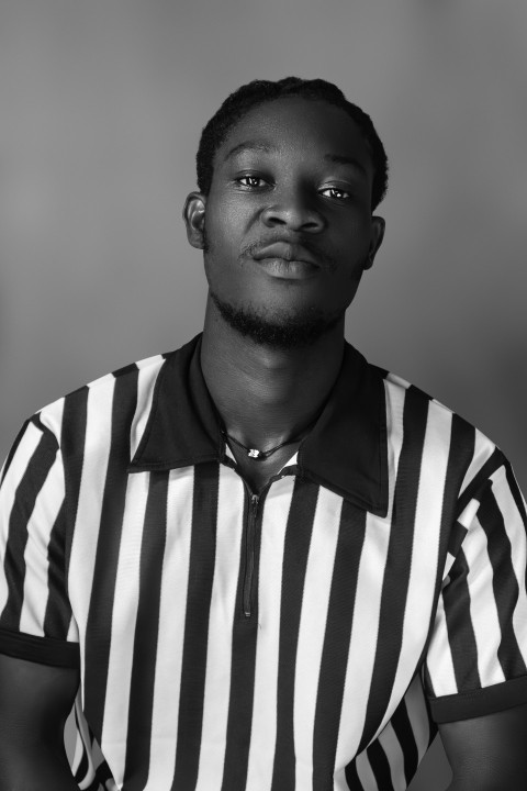 a man in a referees uniform posing for a picture