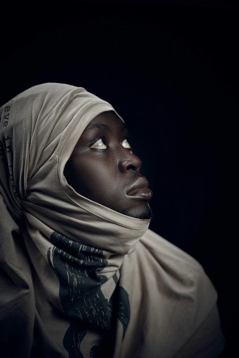 a woman in a headscarf looking up into the sky