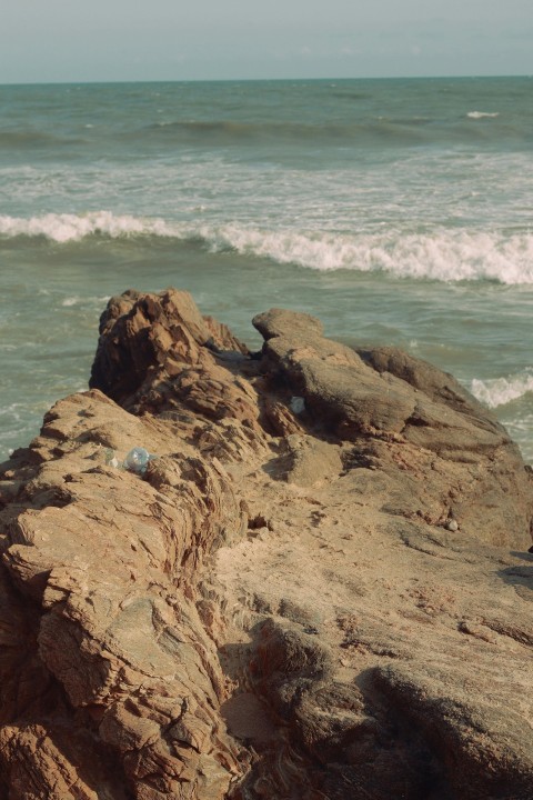 a rocky beach with waves crashing