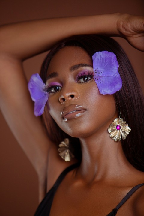 a woman with purple hair and a flower in her hair