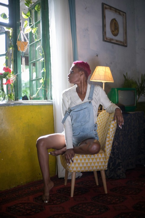 a woman sitting in a chair in a room