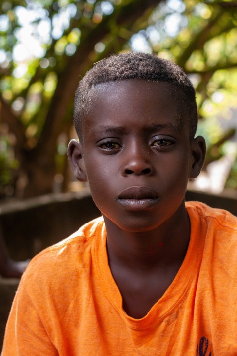 boy in orange crew neck shirt