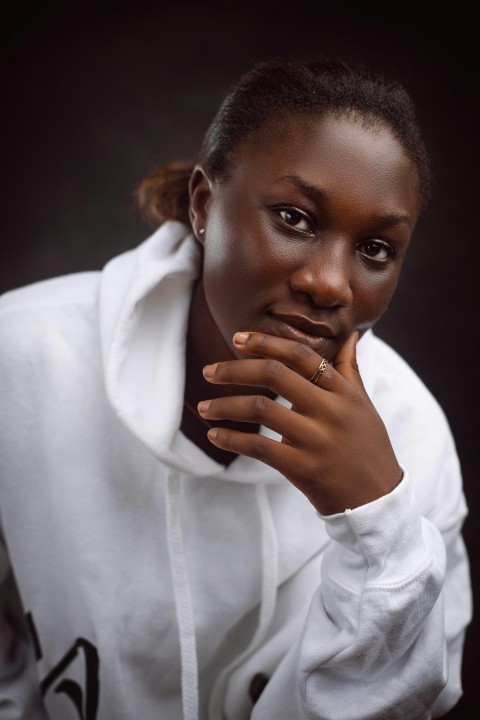 a woman in a white shirt is posing for a picture