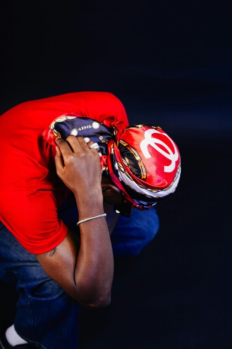 a man in a red shirt and a red helmet