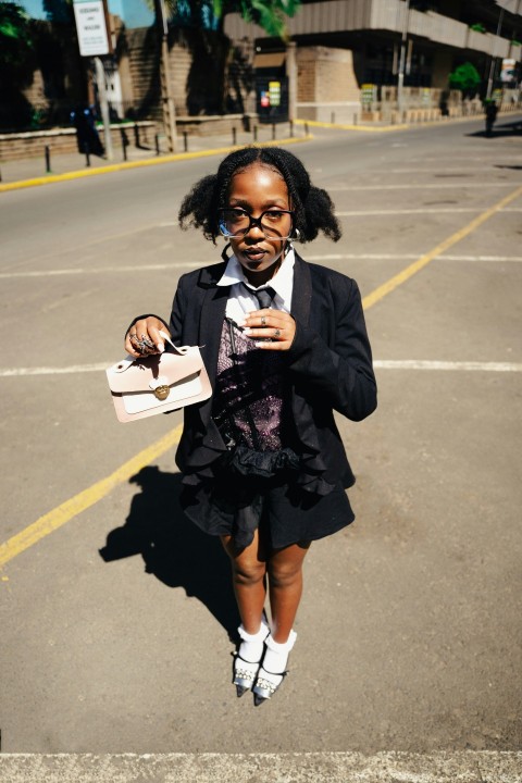 a young girl is walking down the street