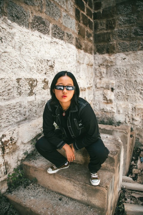 a woman sitting on top of a stone step