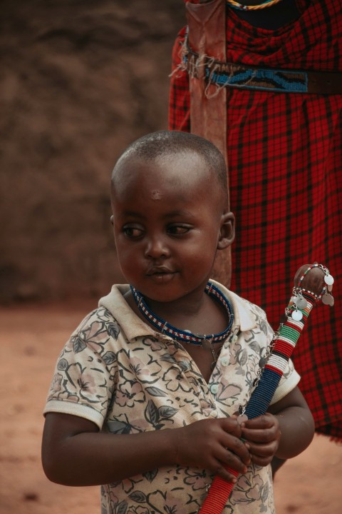 a young boy holding a bottle