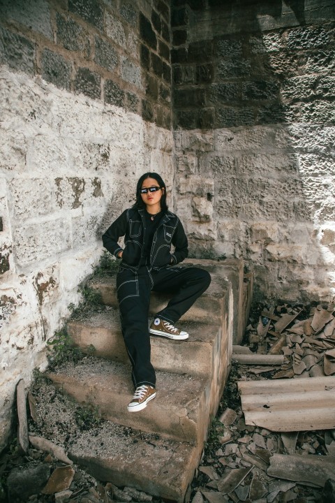 a woman sitting on a set of stairs