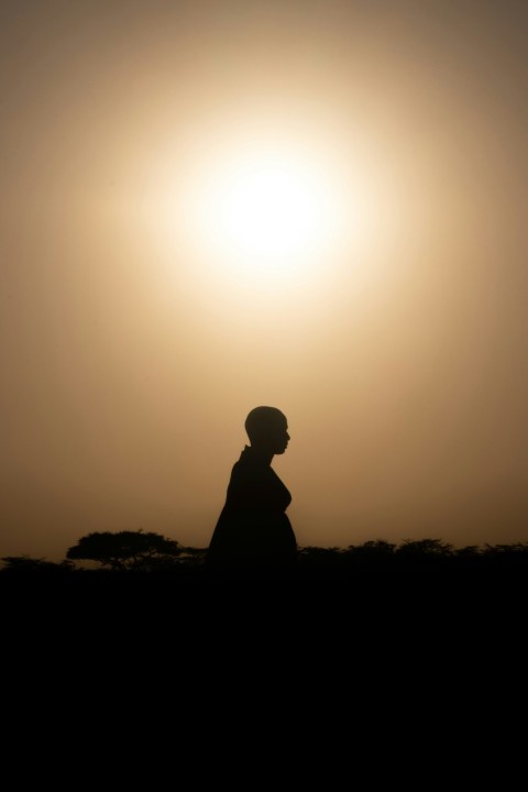 silhouette of man standing during sunset