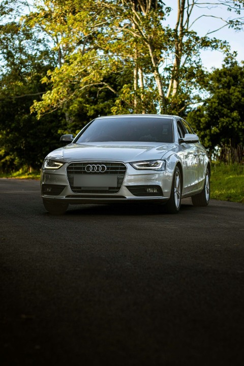 a silver car parked on the side of a road