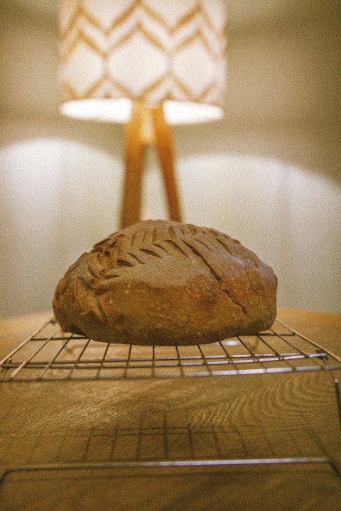 a loaf of bread on a cooling rack FZV6lR4