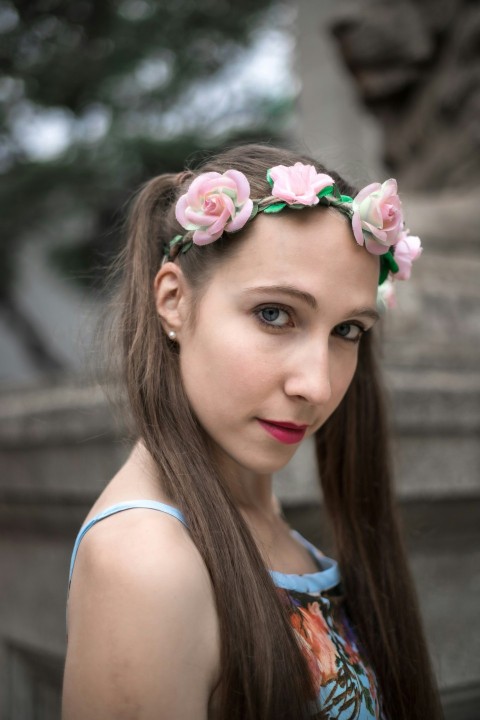 a woman with long hair wearing a flower crown jFid