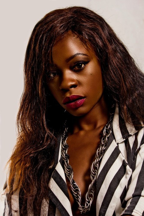 a woman with long hair wearing a striped shirt