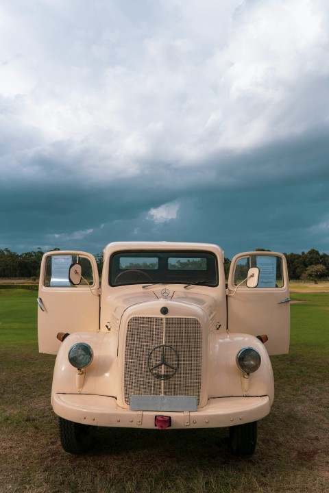 an old truck parked in a field 4vdD0