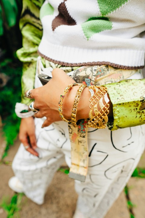 a woman wearing bracelets and bracelets on her arm