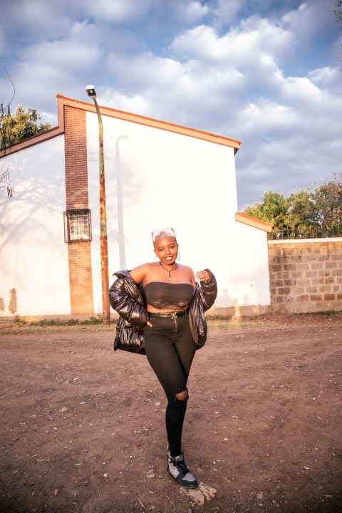 a woman standing in front of a white building O