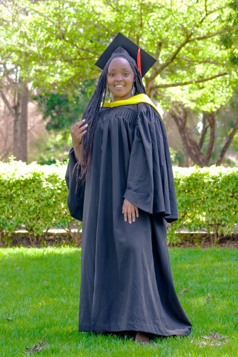 a woman in a graduation gown and cap