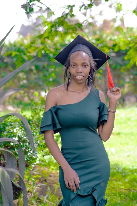 a woman in a graduation cap and gown