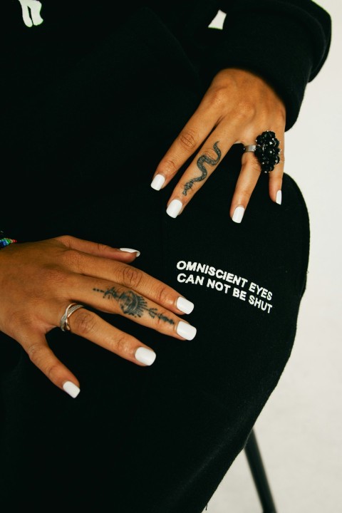 a woman with white nails and a black shirt