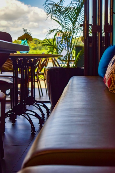 a table and chairs with a view of the ocean