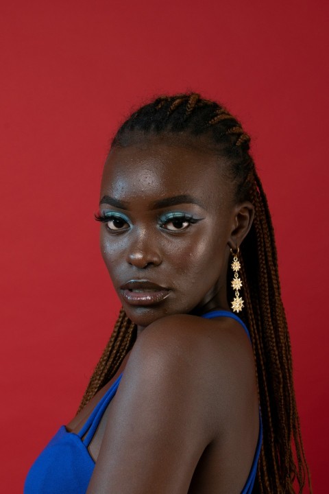 a woman with braids wearing a blue dress