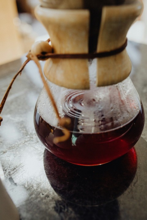 clear glass jar with brown liquid inside