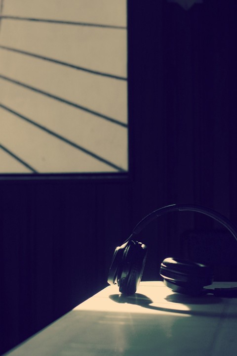 black headphones on black table 0