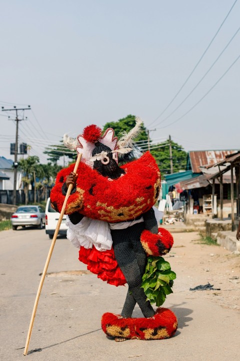 a person in a costume holding a stick