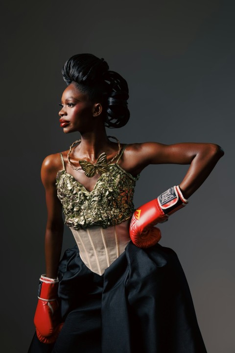 a woman in a dress and boxing gloves